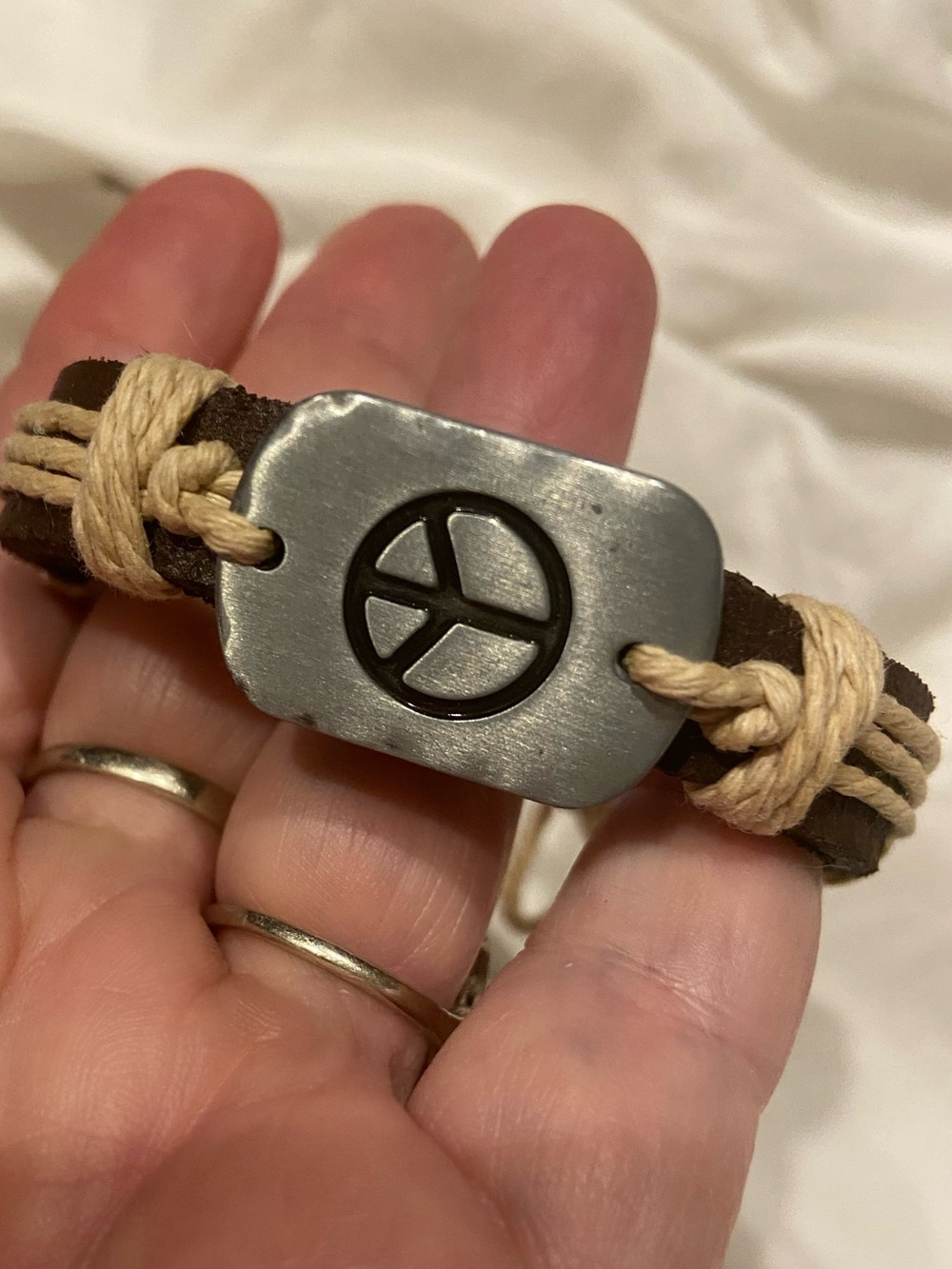 Brown Leather Bracelet with Peace Sign Metal Accent and Cream Cord